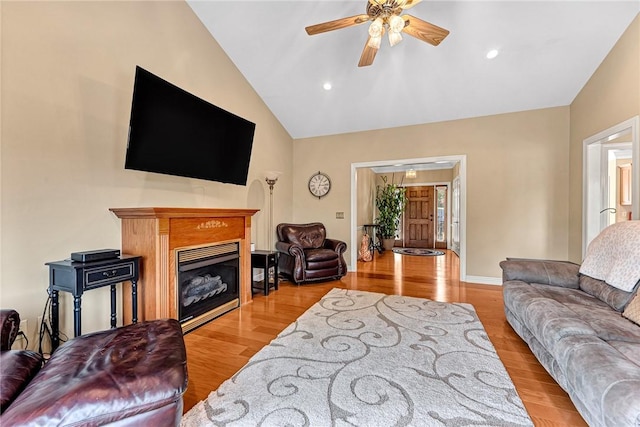 8270 Titleist Cir, Rogers, AR 72756 - living area featuring ceiling fan, light wood-style floors, a glass covered fireplace, high vaulted ceiling, and recessed lighting