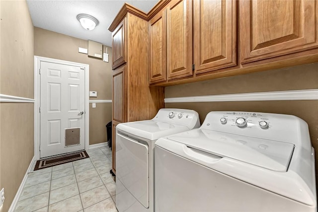 8270 Titleist Cir, Rogers, AR 72756 - laundry area featuring cabinet space, separate washer and dryer, and light tile patterned floors