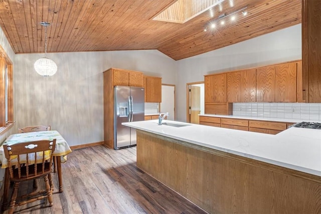 20 Kirkcudbright, Bella Vista, AR 72715 - kitchen featuring stainless steel fridge, vaulted ceiling, light wood-style flooring, wood ceiling, and light countertops