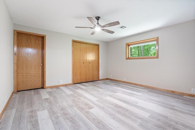 20 Kirkcudbright, Bella Vista, AR 72715 - unfurnished bedroom featuring light wood-style floors, two closets, and a ceiling fan