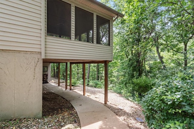 20 Kirkcudbright, Bella Vista, AR 72715 - view of property exterior with a sunroom