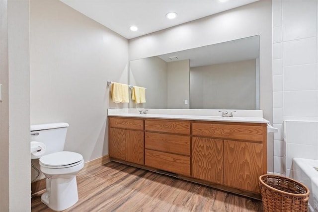 20 Kirkcudbright, Bella Vista, AR 72715 - bathroom featuring wood finished floors, double vanity, a bath, and recessed lighting