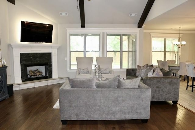 1730 Helen Ln, Bentonville, AR 72713 - living area with dark wood finished floors, a chandelier, healthy amount of natural light, and a fireplace with raised hearth