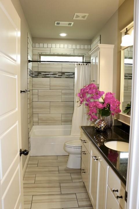 1730 Helen Ln, Bentonville, AR 72713 - bathroom with vanity and shower / bathtub combination with curtain