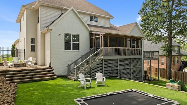 4903 S Inglewood Rd, Rogers, AR 72758 - rear view of property featuring a fire pit, a sunroom, brick siding, stairs, and a shingled roof