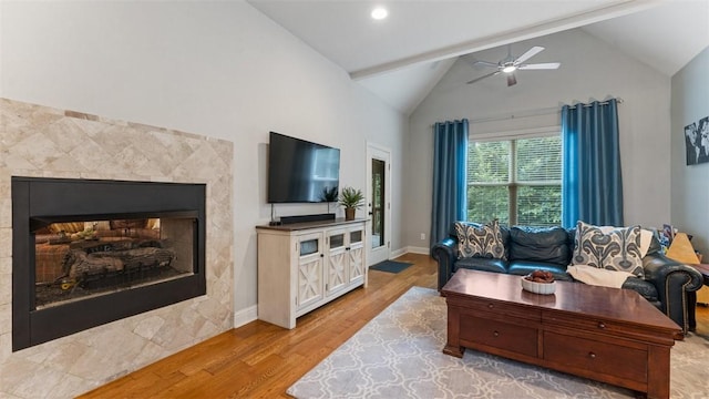 4903 S Inglewood Rd, Rogers, AR 72758 - living area featuring light wood-style flooring, ceiling fan, a multi sided fireplace, beam ceiling, and high vaulted ceiling