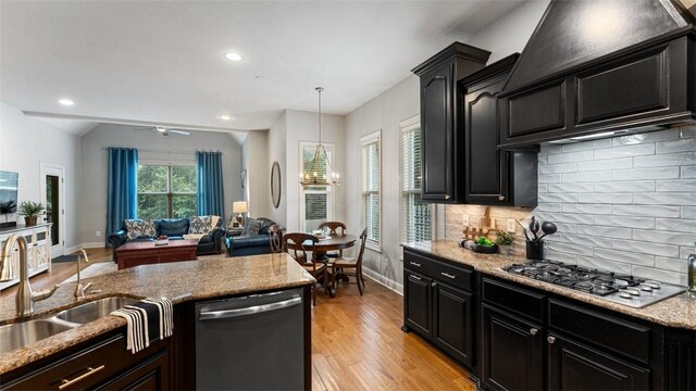 4903 S Inglewood Rd, Rogers, AR 72758 - kitchen with appliances with stainless steel finishes, dark cabinets, exhaust hood, ceiling fan, and recessed lighting