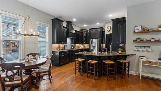4903 S Inglewood Rd, Rogers, AR 72758 - kitchen featuring appliances with stainless steel finishes, premium range hood, dark cabinetry, a chandelier, and recessed lighting