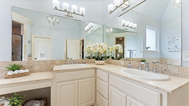 4903 S Inglewood Rd, Rogers, AR 72758 - full bathroom with a stall shower, double vanity, a chandelier, and decorative backsplash
