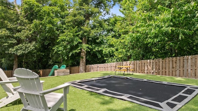 4903 S Inglewood Rd, Rogers, AR 72758 - fenced backyard with a trampoline and a playground