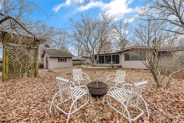 1 Syston Ln, Bella Vista, AR 72714 - view of yard with a fire pit, a sunroom, and a storage unit