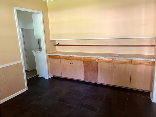 1445 Viewpoint Dr, Fayetteville, AR 72701 - kitchen with freestanding refrigerator, light countertops, and wainscoting