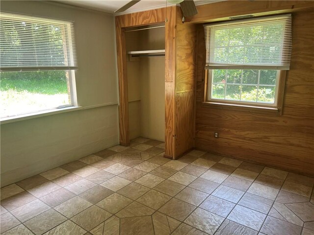 1445 Viewpoint Dr, Fayetteville, AR 72701 - unfurnished bedroom featuring a closet and wooden walls