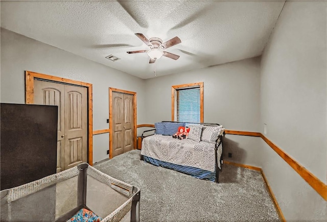 19123 Nokes Farm Rd, Siloam Springs, AR 72761 - bedroom featuring carpet flooring, a textured ceiling, ceiling fan, and multiple closets