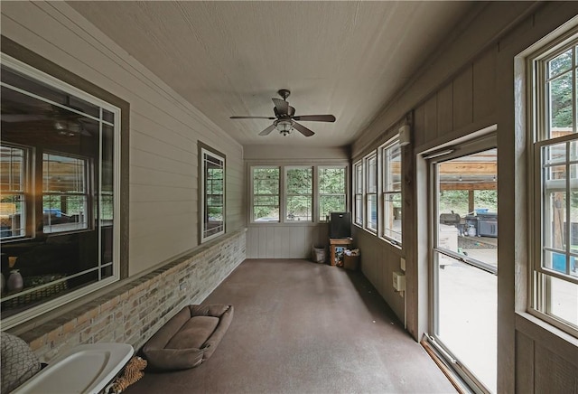 19123 Nokes Farm Rd, Siloam Springs, AR 72761 - unfurnished sunroom featuring a ceiling fan, healthy amount of natural light, and wood walls