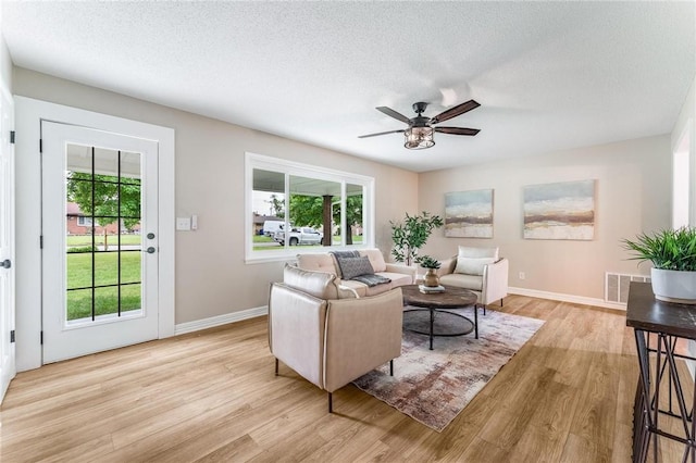 1916 S 12th St, Rogers, AR 72758 - living area with light wood-style flooring, ceiling fan, and a textured ceiling