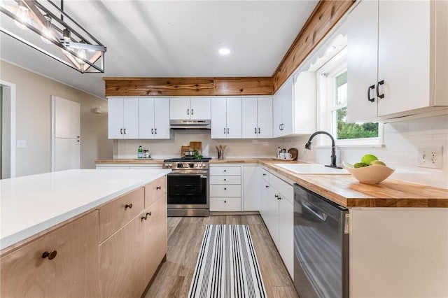 1916 S 12th St, Rogers, AR 72758 - kitchen with stainless steel appliances, under cabinet range hood, decorative backsplash, light wood-type flooring, and recessed lighting