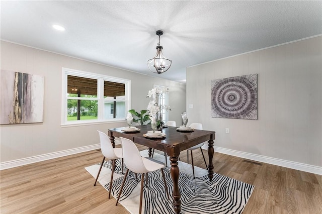 1916 S 12th St, Rogers, AR 72758 - dining room with light wood-style floors, a chandelier, ornamental molding, and a textured ceiling