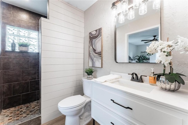 1916 S 12th St, Rogers, AR 72758 - bathroom featuring vanity, a textured wall, walk in shower, a ceiling fan, and wood finished floors