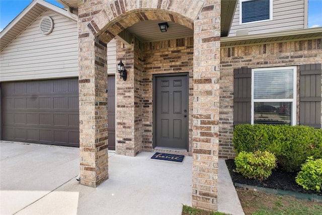4424 Cornwall St, Springdale, AR 72762 - entrance to property with an attached garage, concrete driveway, and brick siding