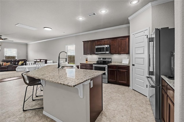 4424 Cornwall St, Springdale, AR 72762 - kitchen with appliances with stainless steel finishes, crown molding, a breakfast bar area, plenty of natural light, and recessed lighting