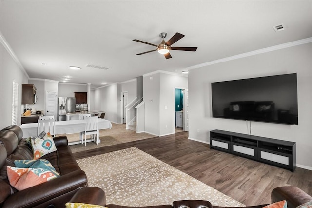 4424 Cornwall St, Springdale, AR 72762 - living room featuring light wood finished floors, crown molding, a ceiling fan, and stairway