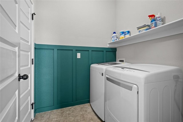 4424 Cornwall St, Springdale, AR 72762 - washroom featuring washing machine and dryer, a decorative wall, and wainscoting