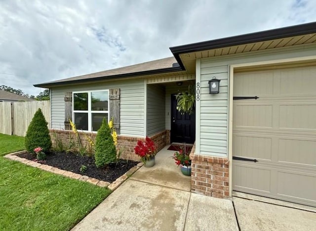 808 NW 69th Ave, Bentonville, AR 72713 - view of exterior entry with an attached garage and brick siding