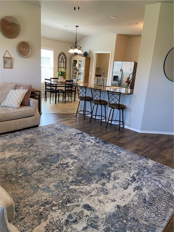 808 NW 69th Ave, Bentonville, AR 72713 - living room with dark wood-style floors and a chandelier