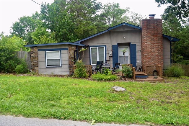 8096 Magnolia Ln, Rogers, AR 72756 - view of front of home featuring stone siding and a chimney