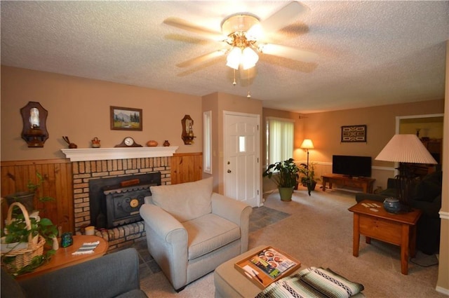8096 Magnolia Ln, Rogers, AR 72756 - carpeted living area featuring a ceiling fan, a textured ceiling, wainscoting, and wood walls