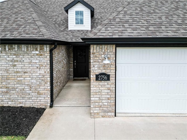 2756 Cassidy Ave, Springdale, AR 72764 - view of exterior entry featuring roof with shingles, a garage, and brick siding
