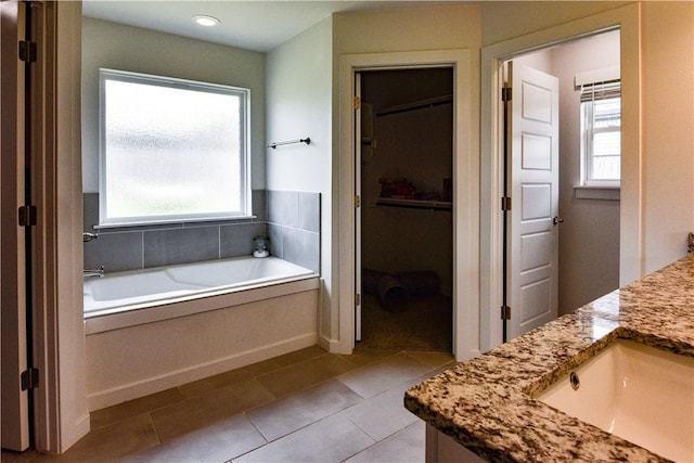 2756 Cassidy Ave, Springdale, AR 72764 - bathroom with vanity, a bath, tile patterned flooring, and a walk in closet