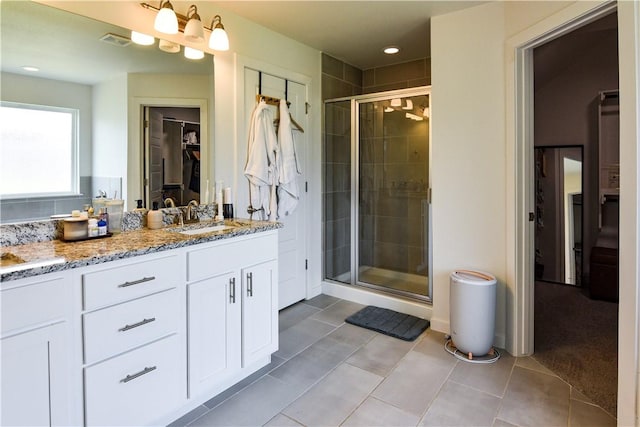 2756 Cassidy Ave, Springdale, AR 72764 - bathroom with vanity, a stall shower, a walk in closet, and tile patterned flooring