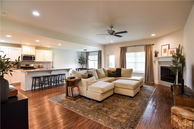 2756 Cassidy Ave, Springdale, AR 72764 - living area featuring a glass covered fireplace, a ceiling fan, dark wood-style flooring, and recessed lighting