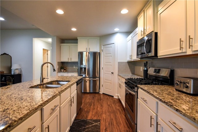2756 Cassidy Ave, Springdale, AR 72764 - kitchen featuring stainless steel appliances, dark wood-style floors, recessed lighting, light stone counters, and tasteful backsplash