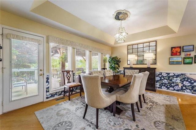 4 Skelton Dr, Bella Vista, AR 72715 - dining space with a tray ceiling, wood finished floors, and a chandelier