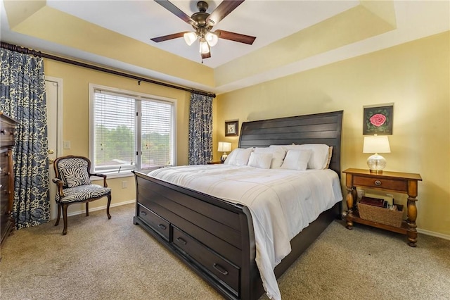 4 Skelton Dr, Bella Vista, AR 72715 - bedroom with a tray ceiling, light colored carpet, and a ceiling fan