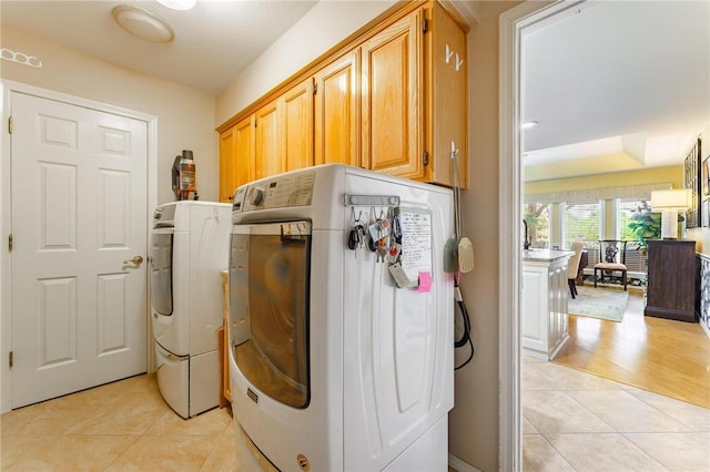 4 Skelton Dr, Bella Vista, AR 72715 - laundry room with light tile patterned floors, separate washer and dryer, and cabinet space