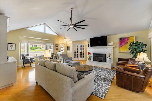 4 Skelton Dr, Bella Vista, AR 72715 - living area with light wood-style flooring, a ceiling fan, a fireplace, lofted ceiling, and french doors