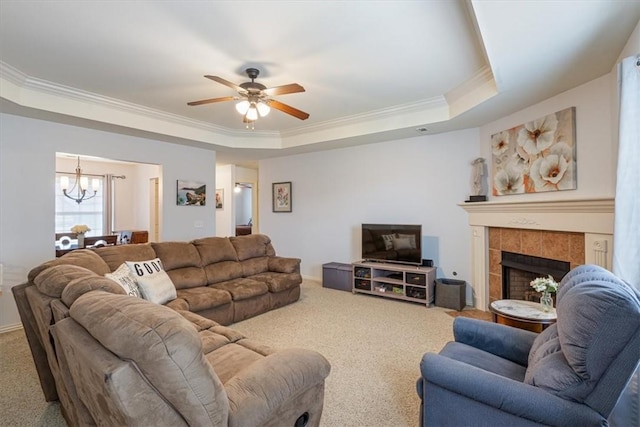 3405 SW Picasso Blvd, Bentonville, AR 72712 - carpeted living room featuring a raised ceiling, a chandelier, crown molding, ceiling fan, and a fireplace