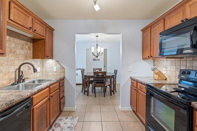 3405 SW Picasso Blvd, Bentonville, AR 72712 - kitchen with black appliances, brown cabinetry, a chandelier, light tile patterned floors, and tasteful backsplash