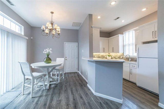 6682 Firefly Catch Ave, Springdale, AR 72762 - dining room with dark wood-type flooring, a chandelier, healthy amount of natural light, and recessed lighting