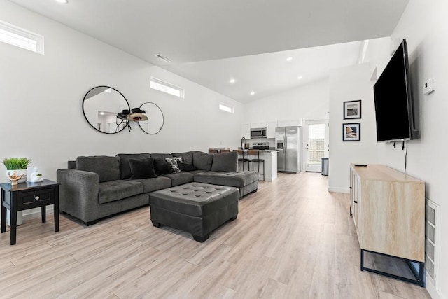 671 St Charles Pl, Bentonville, AR 72713 - living room with light wood-style floors, vaulted ceiling, and recessed lighting