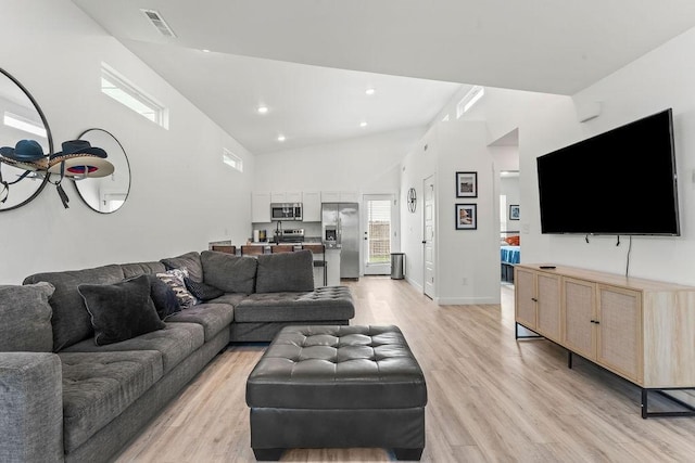671 St Charles Pl, Bentonville, AR 72713 - living room featuring light wood-type flooring, high vaulted ceiling, and recessed lighting