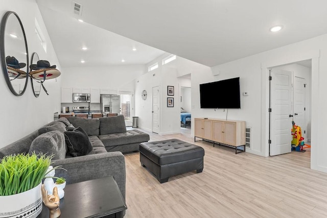671 St Charles Pl, Bentonville, AR 72713 - living room with light wood finished floors, recessed lighting, and a towering ceiling