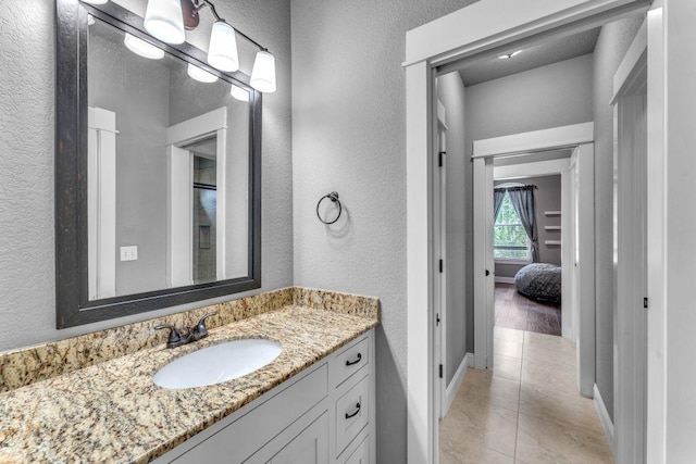 1315 W Magnolia St, Rogers, AR 72758 - bathroom with a textured wall, vanity, and tile patterned flooring
