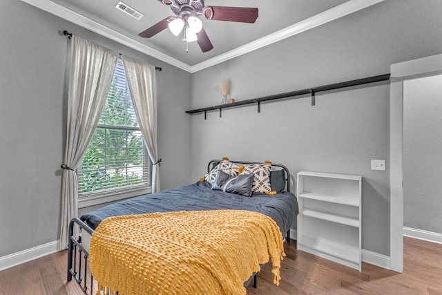 1315 W Magnolia St, Rogers, AR 72758 - bedroom with wood finished floors, ornamental molding, and ceiling fan