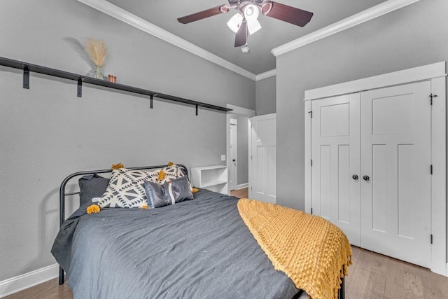 1315 W Magnolia St, Rogers, AR 72758 - bedroom with ornamental molding, wood finished floors, a closet, and ceiling fan