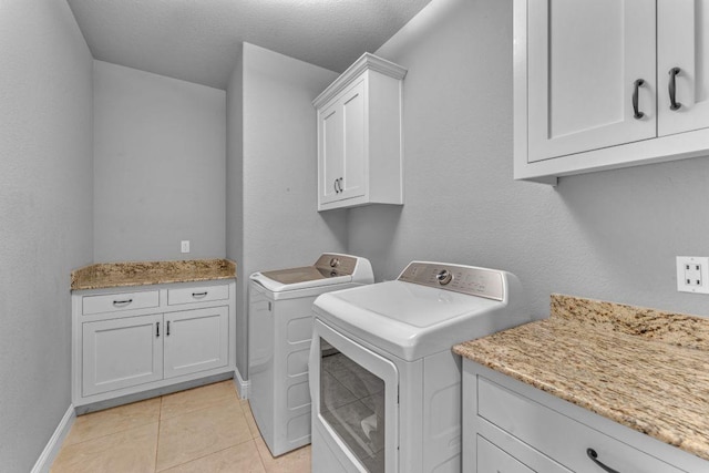 1315 W Magnolia St, Rogers, AR 72758 - laundry room with washer and dryer, cabinet space, and light tile patterned floors